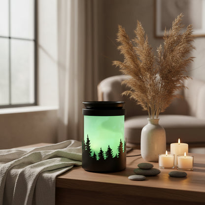 Cylindrical wax melt burner with black top and base, featuring a green sky with silhouettes of trees