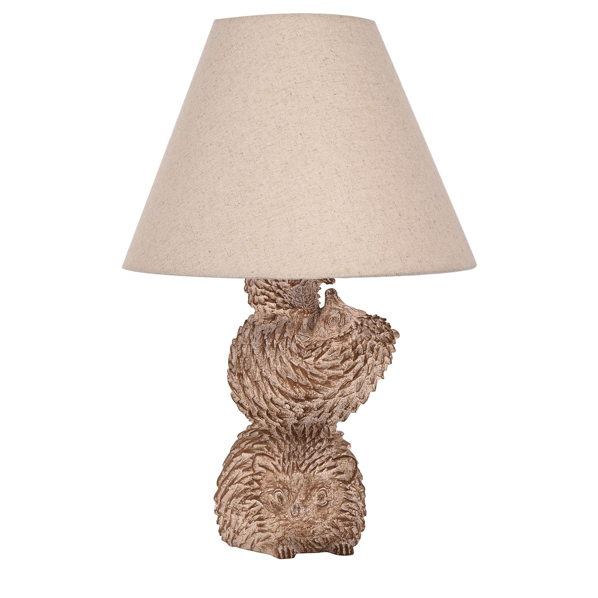Decorative table lamp with hedgehog base and beige lampshade on a white background