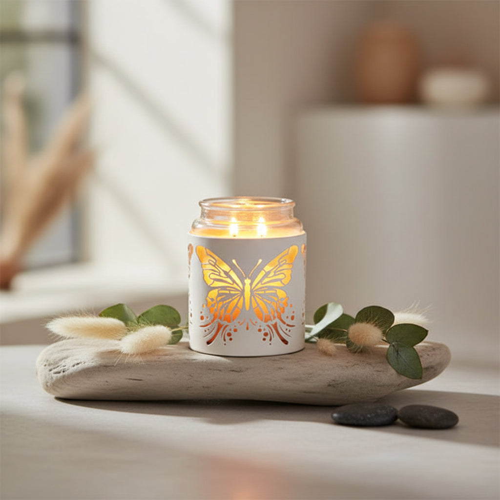 Candle in a holder with a butterfly design 
