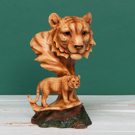 Wooden sculpture of a tiger and cub on a green background