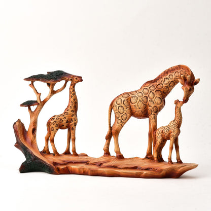 Wood effect resin figurine of a family of giraffes on a white background