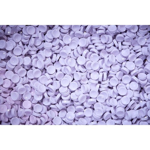 Purple round candy pieces on a white background