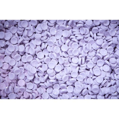 Purple round candy pieces on a white background