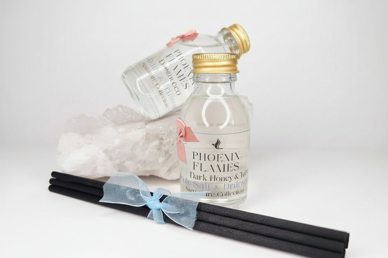 Small bottle labeled 'Phoenix Flames' with a gold cap on a light background