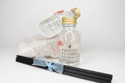 Small bottle labeled 'Phoenix Flames' with a gold cap on a light background