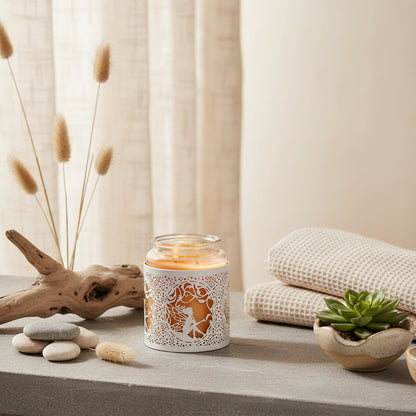 Candle holder with decorative cut-out design featuring a fairy, lit from within 