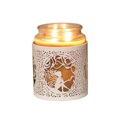 Candle holder with decorative cut-out design featuring a fairy, lit from within on a white background.