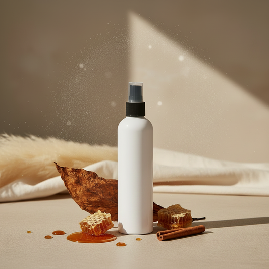 Dark Honey & Tobacco room and linen mist styled with subtle honey, tobacco leaf and cinnamon props in warm amber and mahogany tones