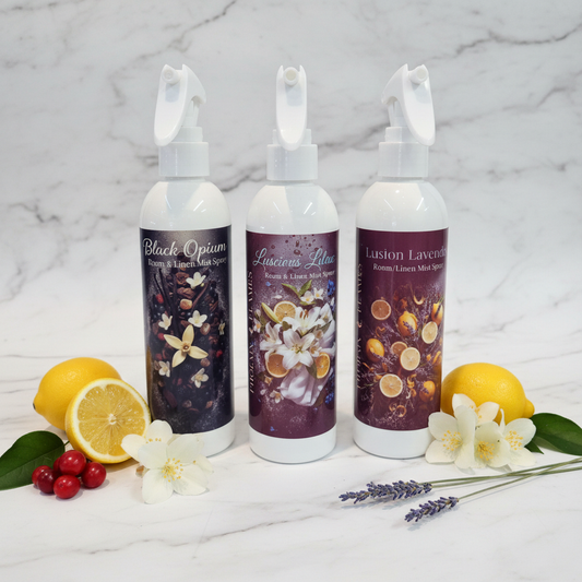 Room and Linen Mist Spray bottles styled on white marble with fresh botanicals